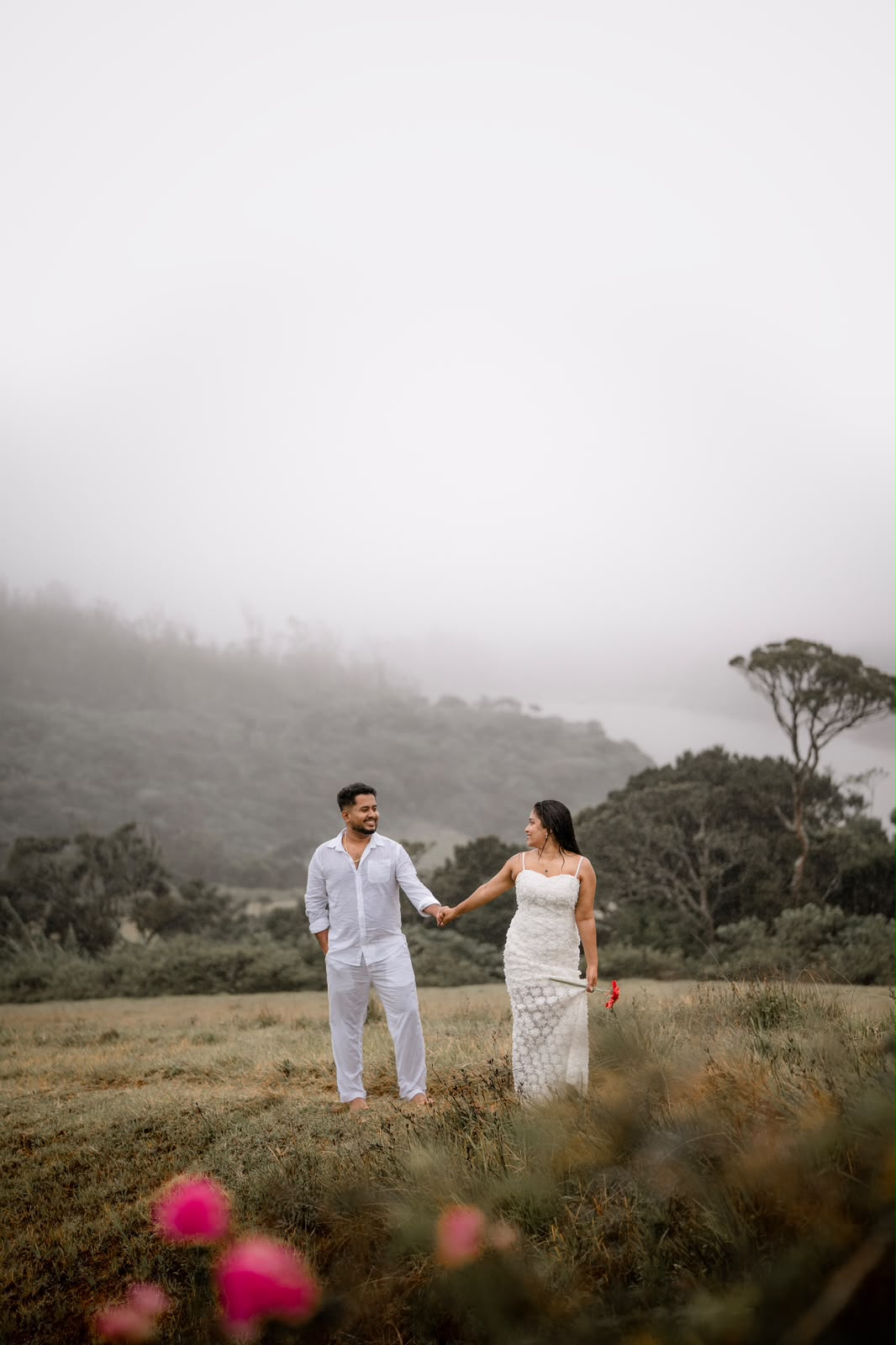 Couple holding hands in a misty landscape